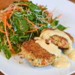 Erin Anais Heist prepares crab cakes with a twisted stalk salad on Friday, May 10, 2019. (Michael Penn | Juneau Empire)