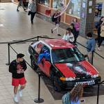 Students look at a car located in the Juneau-Douglas High School: Yadaa.at Kalé commons, May 13, 2019. While the car is an apparent senior prank, it did not cause damage to any property or prove to be a nuisance, administrators said. (Ben Hohenstatt | Juneau Empire)