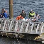 Emergency response crews transport an injured passenger to an ambulance at the George Inlet Lodge docks, Monday, May 13, 2019, in Ketchikan, Alaska. The passenger was from one of two float planes reported down in George Inlet early Monday afternoon and was dropped off by a U.S. Coast Guard 45-foot response boat. (Dustin Safranek | Ketchikan Daily News via AP)