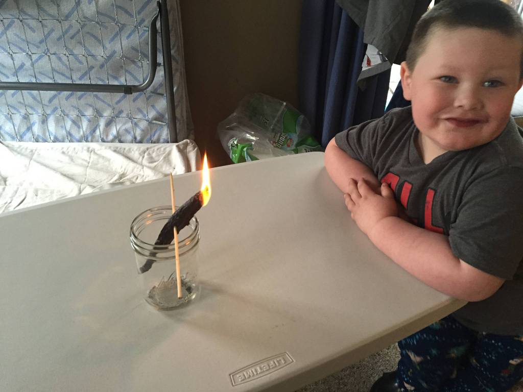 Grandson Jonah smiles with the candlefish/hooligan. (Courtesy Photo | Vivian Faith Prescott)