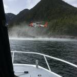 A Coast Guard Air Station Sitka MH-60 Jayhawk helicopter crew hovers while searching for a survivor from a report of two aircraft colliding in the vicinity of George Inlet near Ketchikan, Alaska, May 13, 2019. Ten survivors of the crash had reportedly swam to shore and were rescued by Coast Guard aircrews while the search continues for two people still reported to be missing from the crash. (Courtesy photo | Ryan Sinkey)