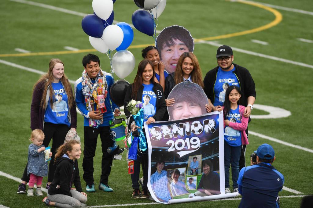 Thunder Mountains Marc Manlulu celebrates Senior Night with his family at TMHS on Tuesday, May 14, 2019. (Michael Penn | Juneau Empire)