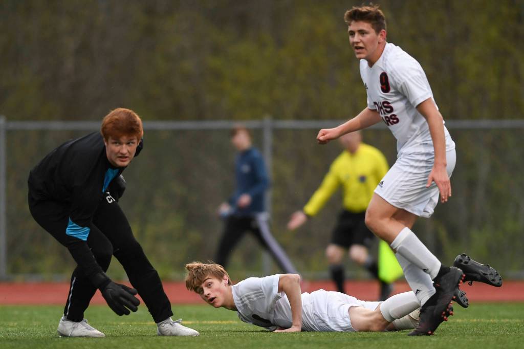 Juneau-Douglass Koby Goldstein, center, watches his goal shot get by Thunder Mountains goal keeper Caleb Traxler at TMHS on Tuesday, May 14, 2019. JDHS won 5-1. (Michael Penn | Juneau Empire)