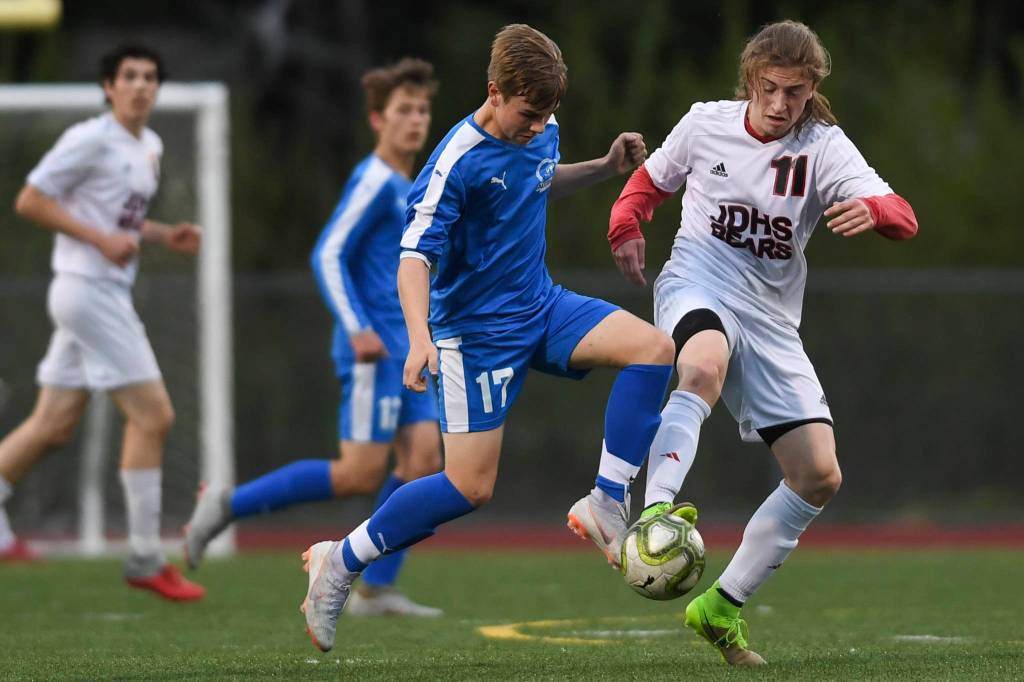 Juneau-Douglas Jackson Norberg, right competes against Thunder Mountains Logan Miller at TMHS on Tuesday, May 14, 2019. JDHS won 5-1. (Michael Penn | Juneau Empire)