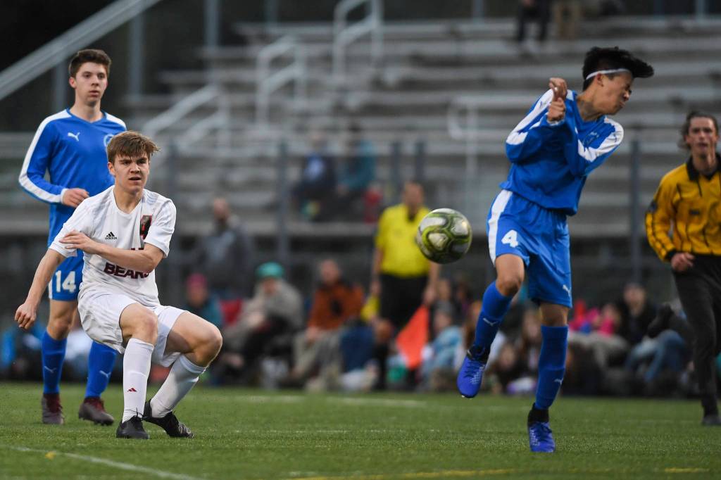 Thunder Mountains Phillip Lam, right, blocks a shot by Juneau-Douglas William Hoover at TMHS on Tuesday, May 14, 2019. JDHS won 5-1. (Michael Penn | Juneau Empire)