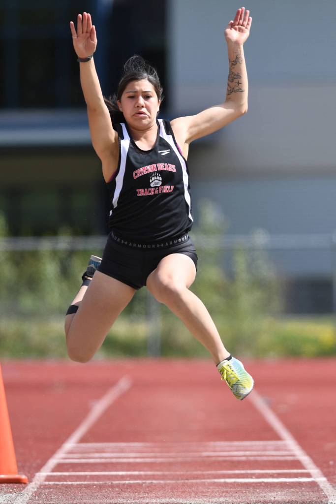 Juneau-Douglas Bailey Wery-Tagaban jumps 16 feet, 1.5 inches to win the girls long jump at the Region V Track and Field Championships at Thunder Mountain High School on Saturday, May 18, 2019. (Michael Penn | Juneau Empire)