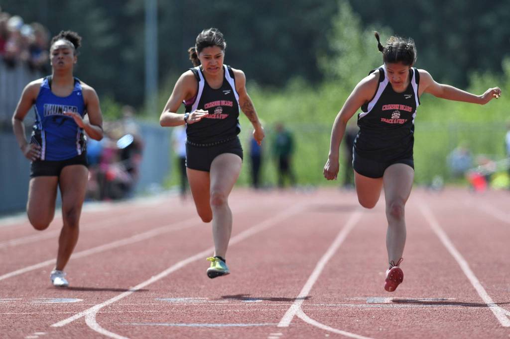 Juneau-Douglas Trinity Jackson, right, stretches for the win ahead of teammate Bailey Wery-Tagaban, center, and Thunder Mountains Iayanah Brewer in the 100-meter dash at the Region V Track and Field Championships at Thunder Mountain High School on Saturday, May 18, 2019. (Michael Penn | Juneau Empire)