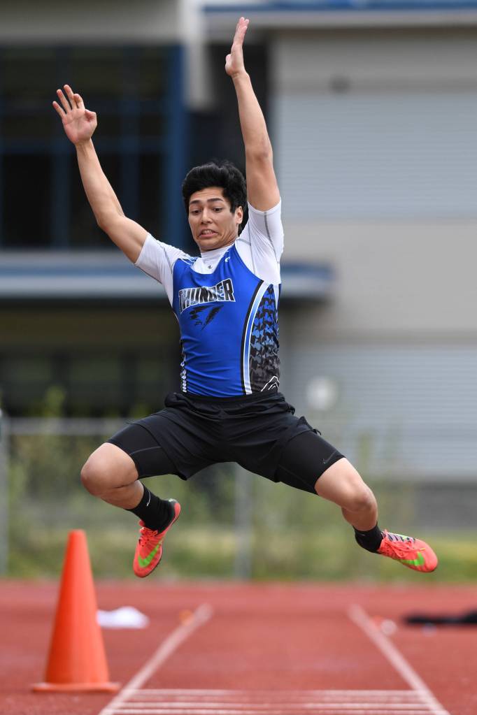Thunder Mountains Aii Beya competes in the boys triple jump at the Region V Track and Field Championships at Thunder Mountain High School on Friday, May 17, 2019. (Michael Penn | Juneau Empire)
