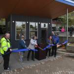 Travel Juneau President & CEO Liz Perry cuts the ribbon during a ceremony to open the new Visitors Center Kiosk in front of the downtown Juneau Public Library on Friday, May 17, 2019. Numerous events celebrated infrastructure improvements by the City and Borough of Juneau Docks & Harbors Department this week. (Michael Penn | Juneau Empire)