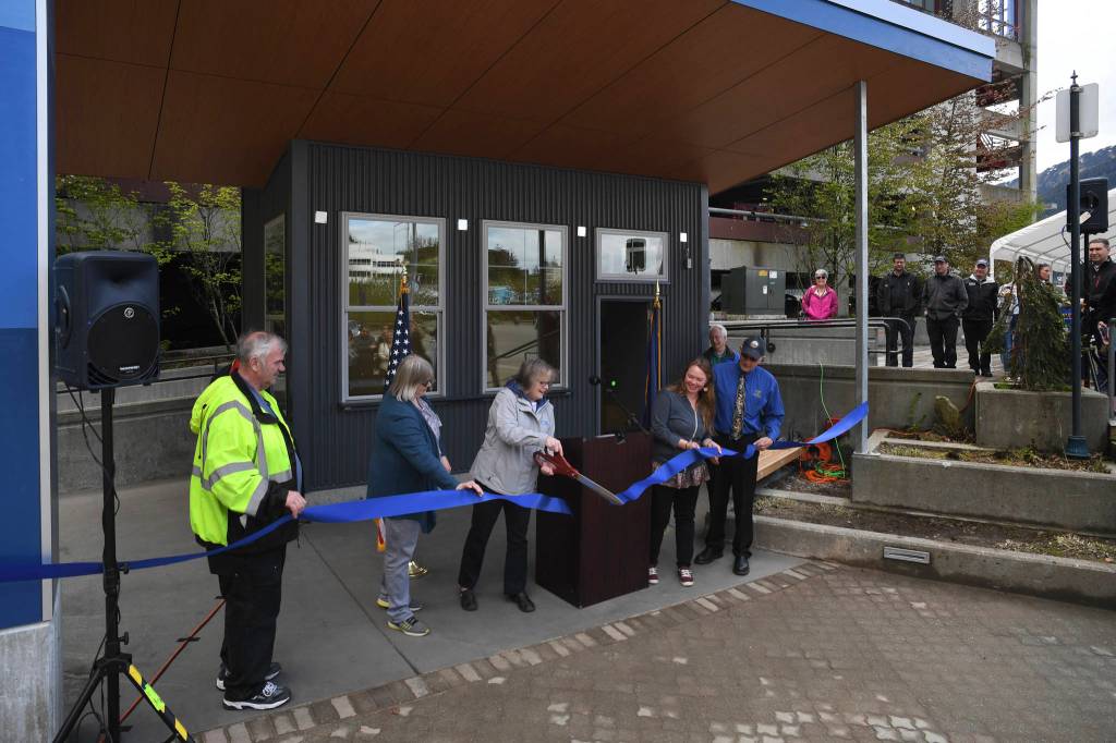 Travel Juneau President & CEO Liz Perry cuts the ribbon during a ceremony to open the new Visitors Center Kiosk in front of the downtown Juneau Public Library on Friday, May 17, 2019. Numerous events celebrated infrastructure improvements by the City and Borough of Juneau Docks & Harbors Department this week. (Michael Penn | Juneau Empire)