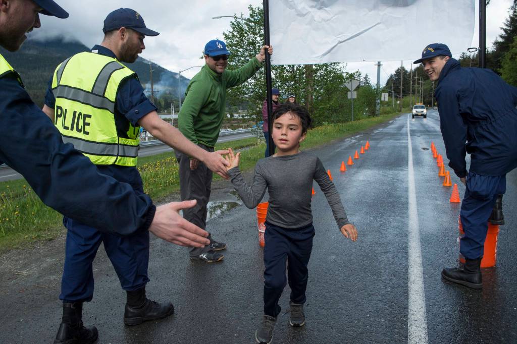 Kindergartener Otto Lindoff is the first to return as Harborview Elementary School holds its annual Fun Run along Glacier Avenue on Friday, May 17, 2019. Students from Montessori Borealis also ran the three-mile course. (Michael Penn | Juneau Empire)