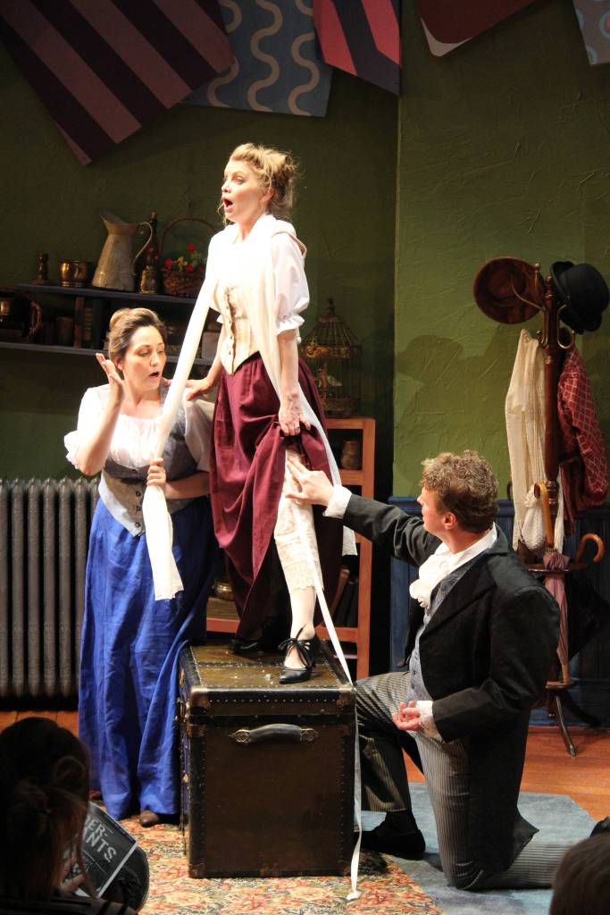 Gertrude (Shadow Meienberg) helps measure Louise (Kelly Gibson) for a special pair of underpants with some assistance from Frank Versati (Ben Brown) during Perseverance Theatres The Underpants. (Courtesy Photo | Perseverance Theatre)