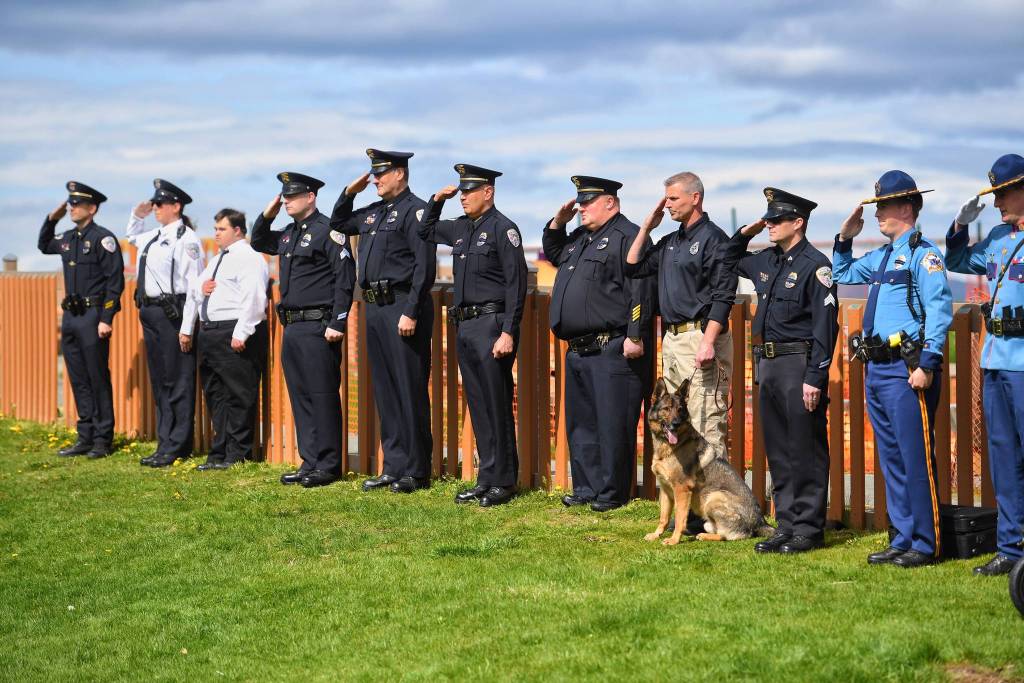 Juneau Police and Alaska State Troopers salute during a police memorial ceremony at Twin Lakes on Saturday, May 18, 2019. (Michael Penn | Juneau Empire)