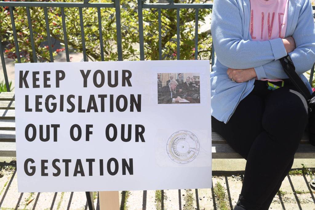 A woman who wished not to be photographed waits for a rally against anti-abortion laws to start at the Dimond Courthouse Plaza on Tuesday, May 21, 2019. (Michael Penn | Juneau Empire)