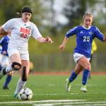 Juneau-Douglas Nikki Box, left, races against Thunder Mountains Kiah Dihle at TMHS on Tuesday, May 14, 2019. JDHS won 3-0. (Michael Penn | Juneau Empire File)