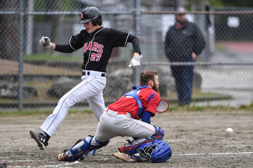 Juneau-Douglas Garrett Bryant scores in front of the throw to Sitkas catcher Morgan Simic in the fourth inning during the Region V Baseball Championship at Adair-Kennedy Memorial Park on Thursday, May 23, 2019. (Michael Penn | Juneau Empire)