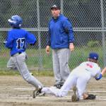 Thunder Mountains Assistant Coach Jake Carte watches as Isaiah Nelson, left, outruns the throw by Sitkas pitcher Cole Riggs during the Region V Baseball Championship at Adair-Kennedy Memorial Park on Friday, May 24, 2019. (Michael Penn | Juneau Empire)