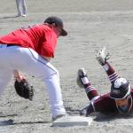 A Ketchikan runner dives back to first base on a pick-off attempt in the Region V title game on Saturday, May 25, 2019. (Alex McCarthy | Juneau Empire)