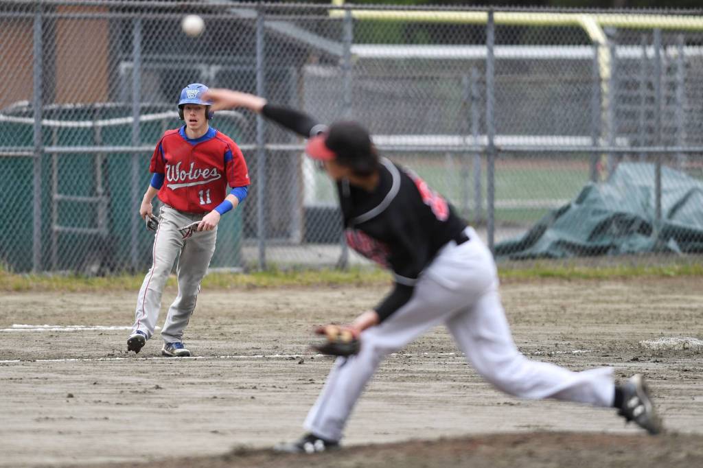 Sitkas base runner Brayden Massey-Jones watches from third base as Juneau-Douglas Garrett Bryant pitches in the first inning during the Region V Baseball Championship at Adair-Kennedy Memorial Park on Thursday, May 23, 2019. (Michael Penn | Juneau Empire)