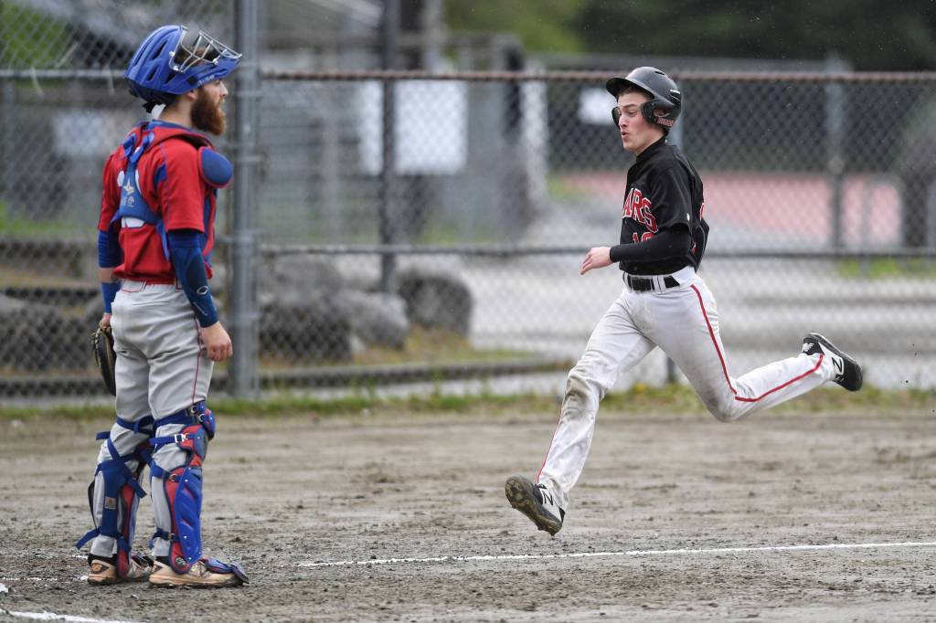 Juneau-Douglas Carter Walker races for home plate on a double by Luis Mojica in the second inning as Sitkas catcher Morgan Simic waits for the ball during the Region V Baseball Championship at Adair-Kennedy Memorial Park on Thursday, May 23, 2019. (Michael Penn | Juneau Empire)