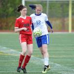 Juneau-Douglas Jasmin Holst and Kodiaks Cassie Sherler battle for the ball at the ASAA/First National Bank Alaska soccer state championships at Service High School in Anchorage on Thursday, May 23, 2019. JDHS won 6-0. (Michael Dinneen | For the Juneau Empire)
