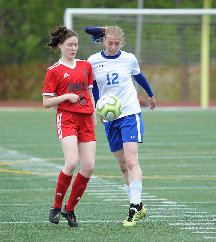Juneau-Douglas Jasmin Holst and Kodiaks Cassie Sherler battle for the ball at the ASAA/First National Bank Alaska soccer state championships at Service High School in Anchorage on Thursday, May 23, 2019. JDHS won 6-0. (Michael Dinneen | For the Juneau Empire)