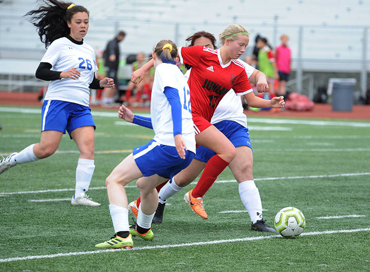 Juneau-Douglas Taylor Bentley busts through a trio of Kodiak defenders at the ASAA/First National Bank Alaska soccer state championships at Service High School in Anchorage on Thursday, May 23, 2019. JDHS won 6-0. (Michael Dinneen | For the Juneau Empire)