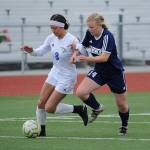 Thunder Mountains Keana Villanueva dribbles past Homers Daisy Kettle during the ASAA/First National Bank Alaska soccer state championships at Eagle River High School on Thursday, May 23, 2019. TMHS won 1-0. (Michael Dinneen | For the Juneau Empire)