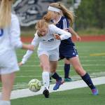 Thunder Mountains Julia Robinson tangles with a Homer defender during the ASAA/First National Bank Alaska soccer state championships at Eagle River High School on Thursday, May 23, 2019. TMHS won 1-0. (Michael Dinneen | For the Juneau Empire)                                Thunder Mountains Julia Robinson tangles with a Homer defender during the ASAA/First National Bank Alaska soccer state championships at Eagle River High School on Thursday, May 23, 2019. TMHS won 1-0. (Michael Dinneen | For the Juneau Empire)