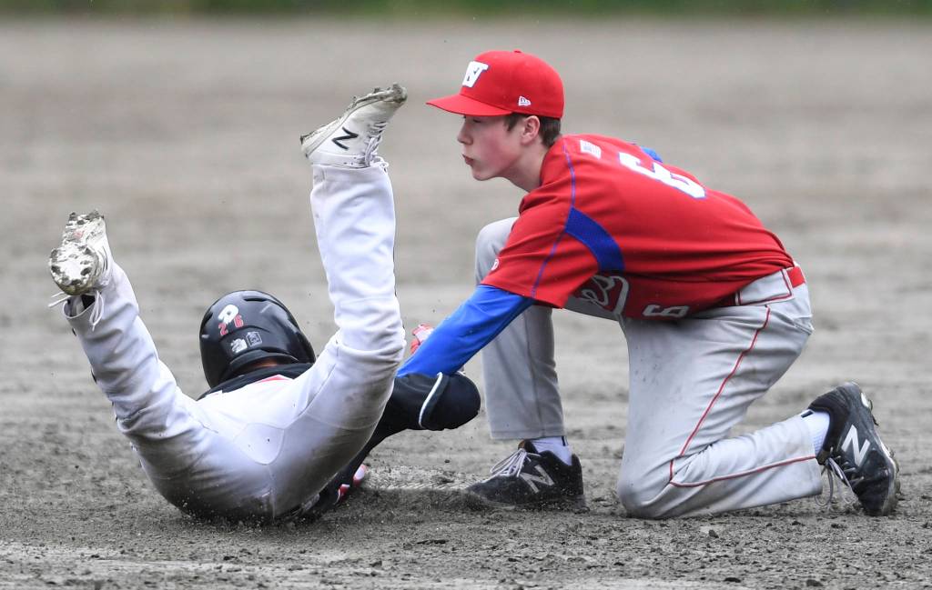Juneau-Douglas Gaby Soto, left, is tagged out on an attempted steal by Sitkas Kyler Brenton during the Region V Baseball Championship at Adair-Kennedy Memorial Park on Thursday, May 23, 2019. JDHS won 6-5. (Michael Penn | Juneau Empire)