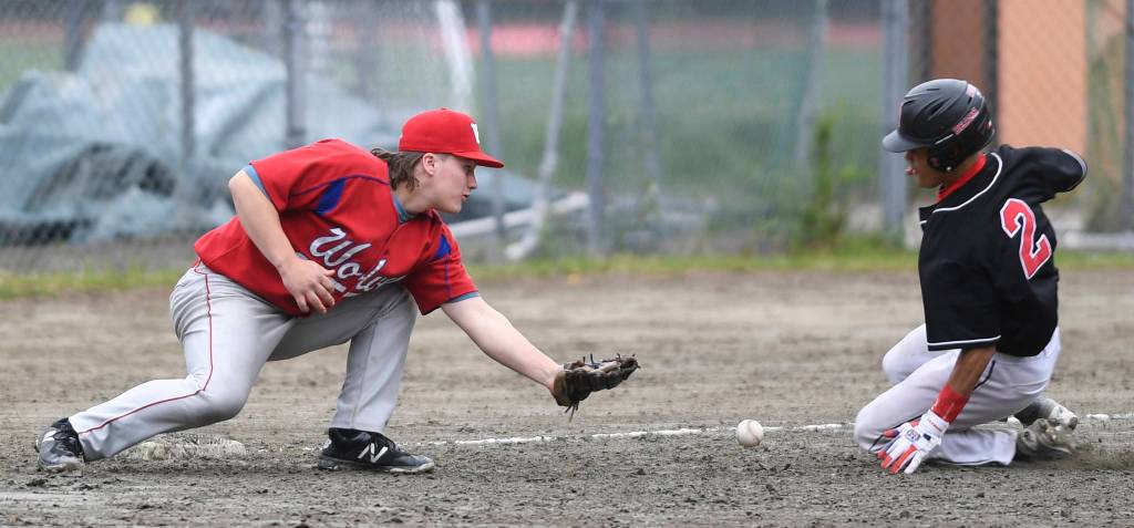 Juneau-Douglas Luis Mojica, right, slides safely into third base as Sitkas Trevin Carley misses the throw during the Region V Baseball Championship at Adair-Kennedy Memorial Park on Thursday, May 23, 2019. JDHS won 6-5. (Michael Penn | Juneau Empire)