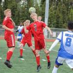 Juneau-Douglas Koby Goldstein, center, heads the ball as teammate Richard Lehner looks on during the first half of their ASAA/First National Bank Alaska soccer state championship match Thursday evening at Service High School in Anchorage. For Palmer are Makeehan Knittle, left and Pedro Gonzalez. (Michael Dinneen | For the Juneau Empire)