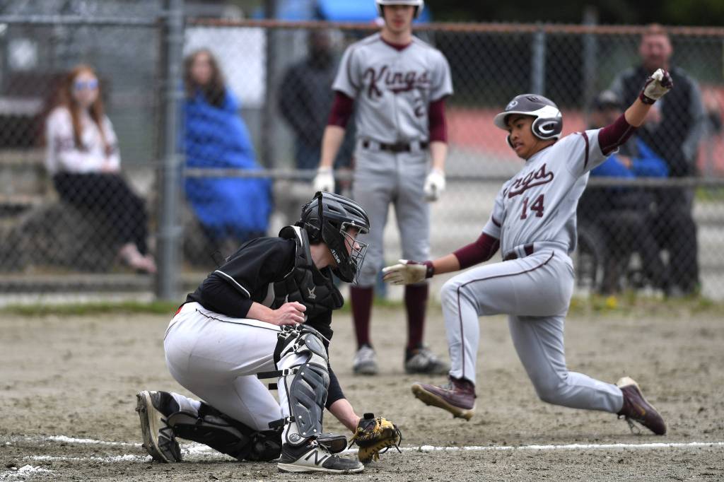 Ketchikans CJ Paula is tagged out at home by Juneau-Douglas Brock McCormick during the Region V Baseball Championship at Adair-Kennedy Memorial Park on Friday, May 24, 2019. (Michael Penn | Juneau Empire)