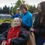Charlotte Bain, 94, attends a tailgate party with her daughter, Claudia Bain, her granddaughter, Megan White, and her great-granddaughter, Louisa White, 21 months, before the Juneau Alumni Football Game with football players, dance team members and cheerleaders from Juneau-Douglas and Thunder Mountain High Schools at Adair-Kennedy Memorial Field on Friday, May 24, 2019. They were there to support Bains grandson, James, who was playing for the Juneau Legends. White graduated in 2000. (Michael Penn | Juneau Empire)