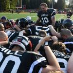 Chris Connally leads a prayer before the Juneau Alumni Football Game with football players, dance team members and cheerleaders from Juneau-Douglas and Thunder Mountain High Schools at Adair-Kennedy Memorial Field on Friday, May 24, 2019. (Michael Penn | Juneau Empire)