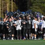 Players from both teams meet at midfield for the Juneau Alumni Football Game with football players, dance team members and cheerleaders from Juneau-Douglas and Thunder Mountain High Schools at Adair-Kennedy Memorial Field on Friday, May 24, 2019. (Michael Penn | Juneau Empire)