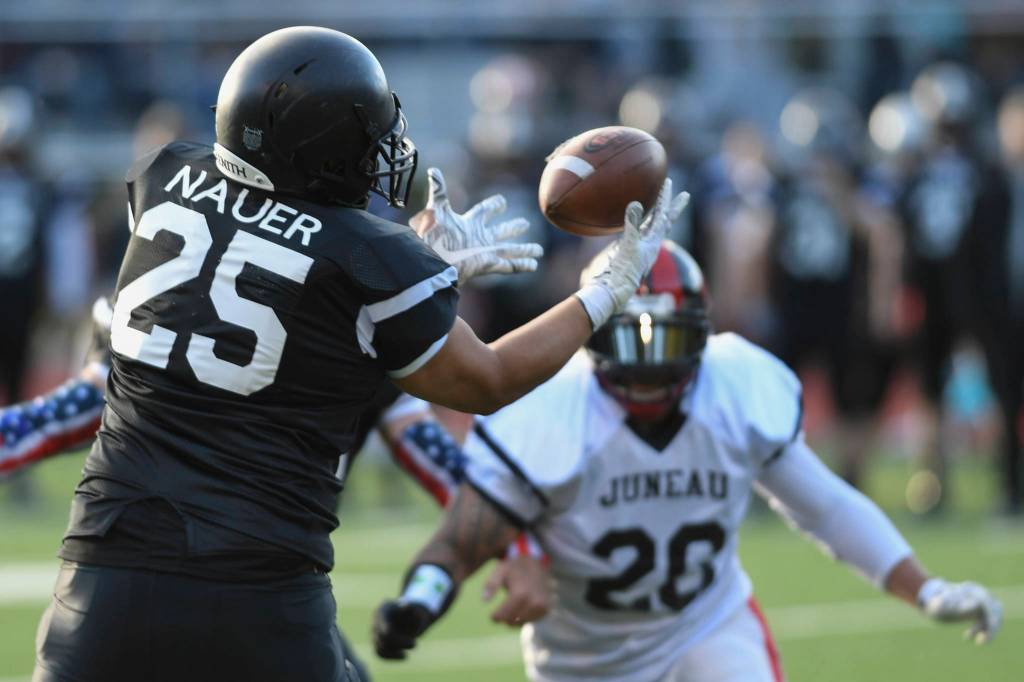 Legends Sam Nauer intercepts the ball during the Juneau Alumni Football Game with football players, dance team members and cheerleaders from Juneau-Douglas and Thunder Mountain High Schools at Adair-Kennedy Memorial Field on Friday, May 24, 2019. (Michael Penn | Juneau Empire)