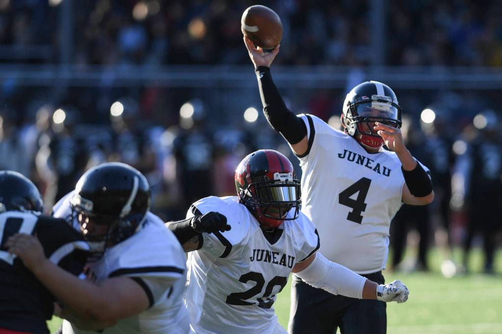Stars Angelo Katasse passes during the Juneau Alumni Football Game with football players, dance team members and cheerleaders from Juneau-Douglas and Thunder Mountain High Schools at Adair-Kennedy Memorial Field on Friday, May 24, 2019. (Michael Penn | Juneau Empire)