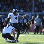 Stars Angelo Katasse kicks an extra point with the help of Ryan Fagerstrom during the Juneau Alumni Football Game with football players, dance team members and cheerleaders from Juneau-Douglas and Thunder Mountain High Schools at Adair-Kennedy Memorial Field on Friday, May 24, 2019. (Michael Penn | Juneau Empire)