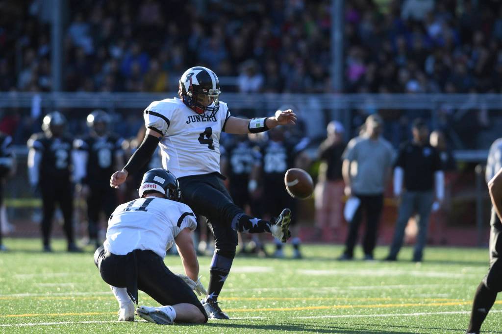 Stars Angelo Katasse kicks an extra point with the help of Ryan Fagerstrom during the Juneau Alumni Football Game with football players, dance team members and cheerleaders from Juneau-Douglas and Thunder Mountain High Schools at Adair-Kennedy Memorial Field on Friday, May 24, 2019. (Michael Penn | Juneau Empire)