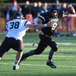 Legends Stefan Jones, right, is pursued by Stars Dylan Skrzynski in the Juneau Alumni Football Game with football players, dance team members and cheerleaders from Juneau-Douglas and Thunder Mountain High Schools at Adair-Kennedy Memorial Field on Friday, May 24, 2019. (Michael Penn | Juneau Empire)