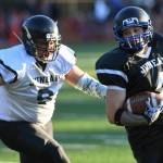 Legends Matthew Maka, right, is chased by Stars Romney Tupou in the Juneau Alumni Football Game with football players, dance team members and cheerleaders from Juneau-Douglas and Thunder Mountain High Schools at Adair-Kennedy Memorial Field on Friday, May 24, 2019. (Michael Penn | Juneau Empire)