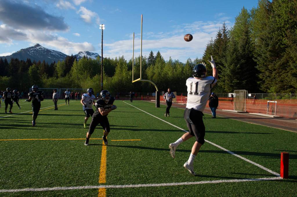 Stars Ryan Fagerstrom makes a reception for the first touchdown of the night at the Juneau Alumni Football Game with football players, dance team members and cheerleaders from Juneau-Douglas and Thunder Mountain High Schools at Adair-Kennedy Memorial Field on Friday, May 24, 2019. (Michael Penn | Juneau Empire)