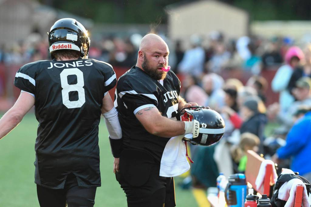 Legends Brandon Ridle, right, and Stefan Jones towel off during the Juneau Alumni Football Game with football players, dance team members and cheerleaders from Juneau-Douglas and Thunder Mountain High Schools at Adair-Kennedy Memorial Field on Friday, May 24, 2019. (Michael Penn | Juneau Empire)