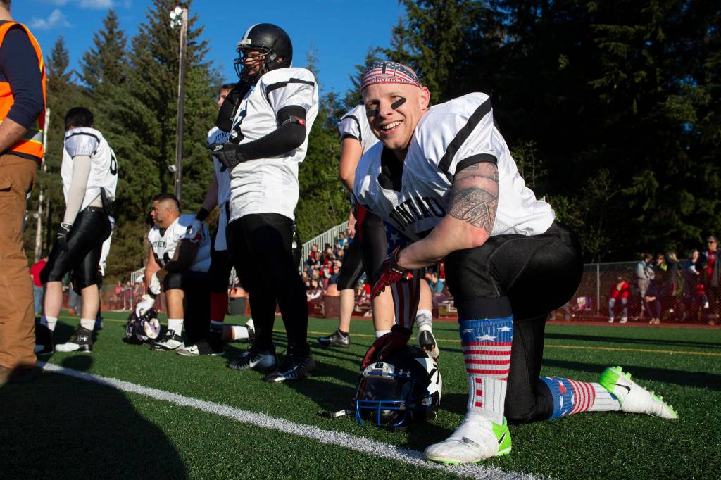 Stars player Mike Wright kneels during the Juneau Alumni Football Game at Adair-Kennedy Memorial Field on Friday, May 24, 2019. (Michael Penn | Juneau Empire)