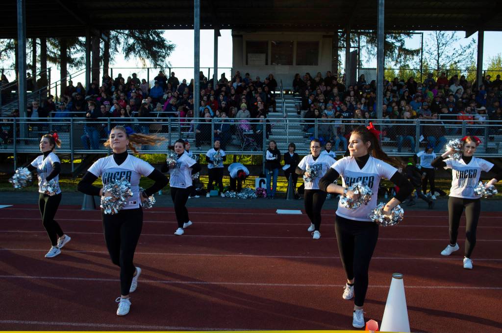 Cheerleaders perform during the Juneau Alumni Football Game with football players, dance team members and cheerleaders from Juneau-Douglas and Thunder Mountain High Schools at Adair-Kennedy Memorial Field on Friday, May 24, 2019. (Michael Penn | Juneau Empire)