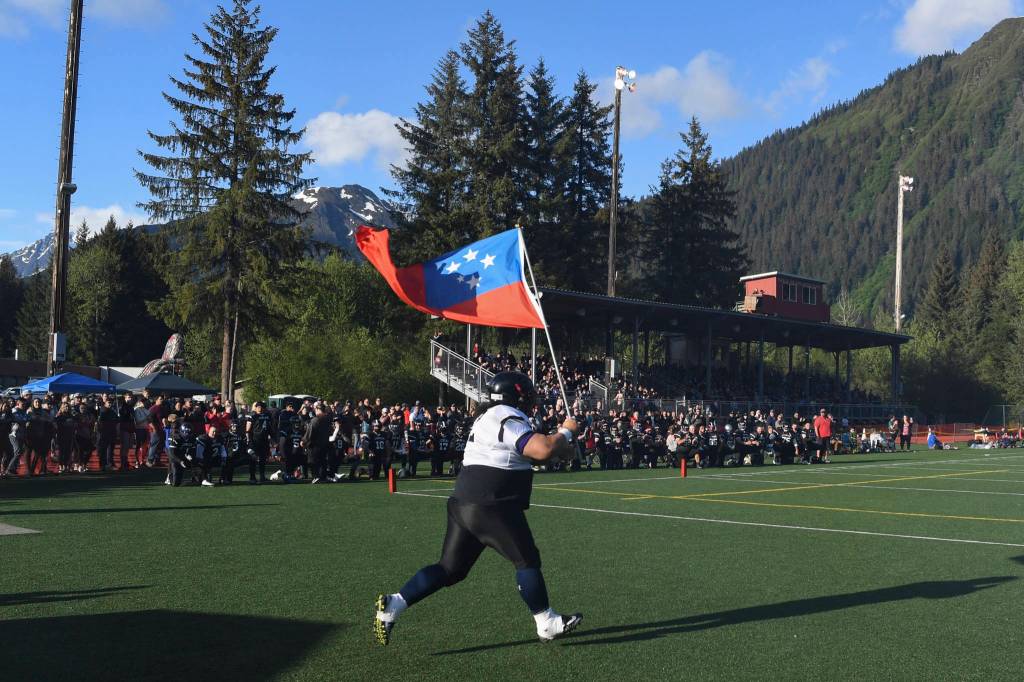 Juneau Stars Lino Fenumiai, a graduate of 2000, enters the field for the 1st annual Juneau Alumni Football Game with football players, dance team members and cheerleaders from Juneau-Douglas and Thunder Mountain High Schools at Adair-Kennedy Memorial Field on Friday, May 24, 2019. (Michael Penn | Juneau Empire)