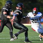 Stars Lance Fenumiai, right, is persued by Legends Tommy Penrose, center, and Jake Ritter in the 1st annual Juneau Alumni Football Game with football players, dance team members and cheerleaders from Juneau-Douglas and Thunder Mountain High Schools at Adair-Kennedy Memorial Field on Friday, May 24, 2019. (Michael Penn | Juneau Empire)