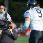 A video crew from NFL Films documents the 1st annual Juneau Alumni Football Game with football players, dance team members and cheerleaders from Juneau-Douglas and Thunder Mountain High Schools at Adair-Kennedy Memorial Field on Friday, May 24, 2019. (Michael Penn | Juneau Empire)