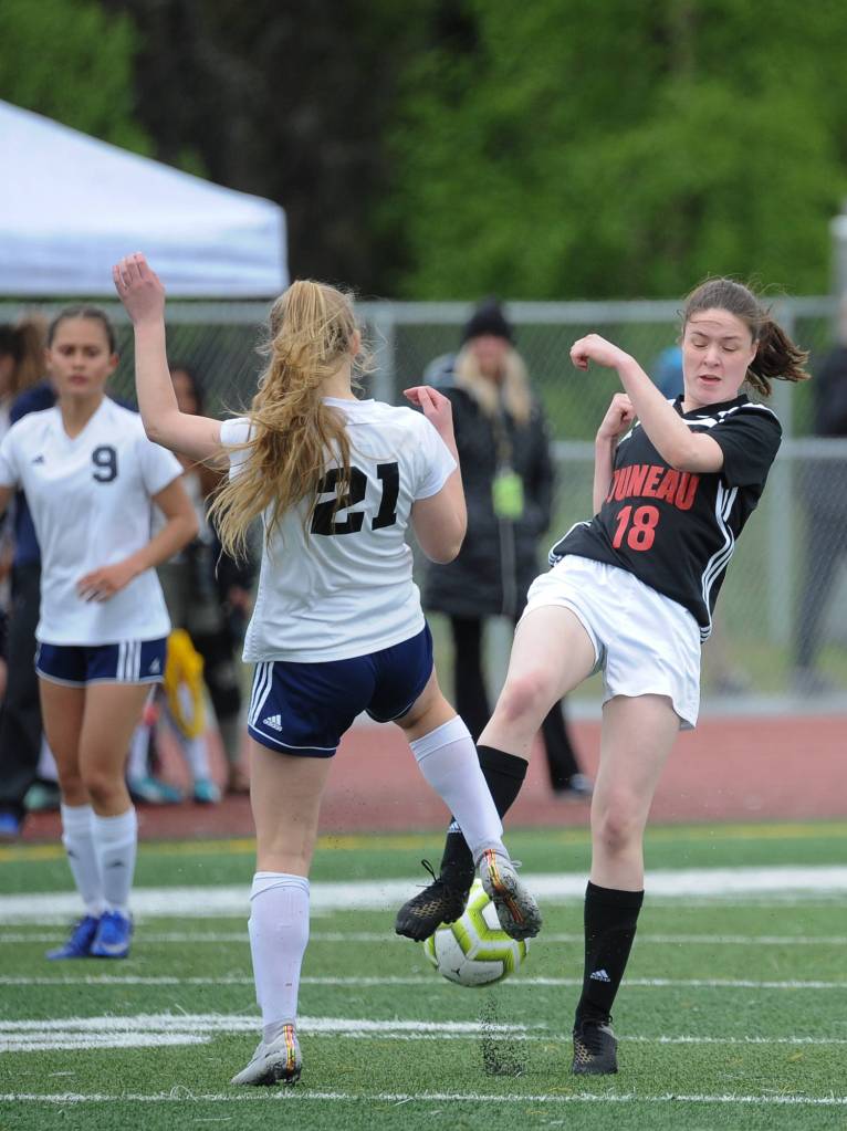Juneau-Douglas Jasmin Holst and Soldotnas Jolie Widiman battle over the ball in the second half of JDHS 5-1 win in over Soldotna in the the ASAA/First National Bank Alaska soccer state championship match Saturday afternoon at Service High School in Anchorage. (Michael Dinneen | For the Juneau Empire)